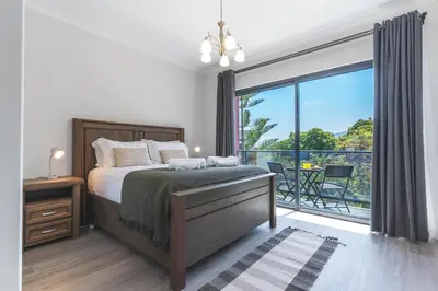 a bedroom with a bed and a large window at Blue Outlook Garden by Atlantic Holiday in Água de Pena