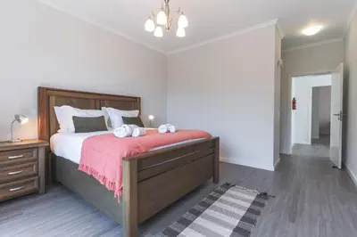 a bedroom with a large bed with two white towels on it at Blue Outlook Garden by Atlantic Holiday in Água de Pena