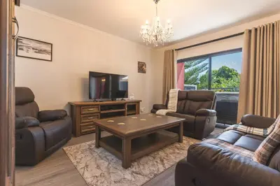 a living room with a couch and a tv at Blue Outlook Garden by Atlantic Holiday in Água de Pena