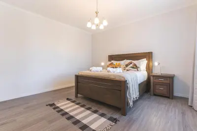 a bedroom with a bed with a nightstand and a bed sidx sidx sidx sidx at Blue Outlook Retreat by Atlantic Holiday in Água de Pena