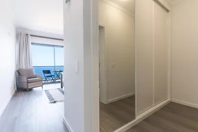 a room with a sliding glass door with a chair at Blue Outlook View by Atlantic Holiday in Água de Pena