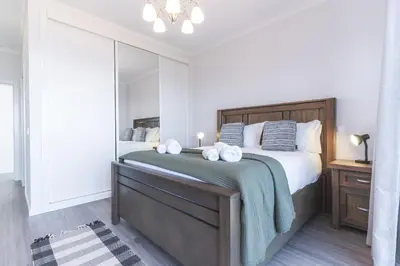 a bedroom with a large bed with a large mirror at Blue Outlook View by Atlantic Holiday in Água de Pena