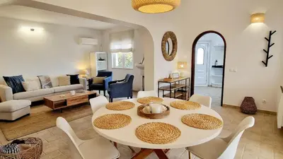 a living room with a white table and chairs at Casa Contente 3-bedroom villa with pool in Luz