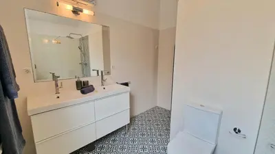 a bathroom with a sink and a large mirror at Casa Contente 3-bedroom villa with pool in Luz