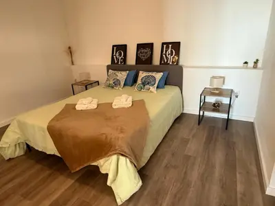 a bedroom with a bed with two towels on it at São Lourenço 3 in Caniçal