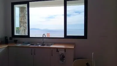 a kitchen with a sink and two large windows at São Lourenço 3 in Caniçal