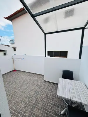a balcony with a bench and a white wall at Vila Ramos II-Funchal in Funchal