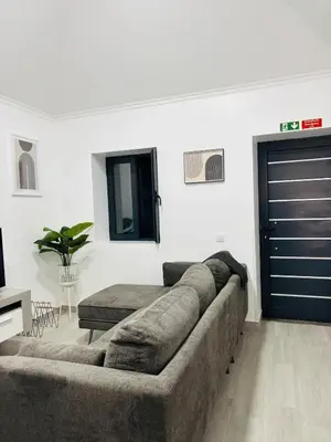 a living room with a couch and a door at Vila Ramos II-Funchal in Funchal