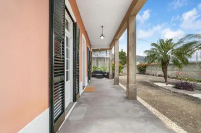 a corridor of a house with a sidewalk at Akosuah's Villa in Funchal