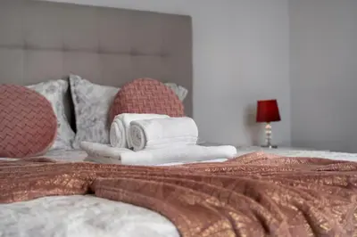 a bed with towels and pillows on top of it at Akosuah's Villa in Funchal