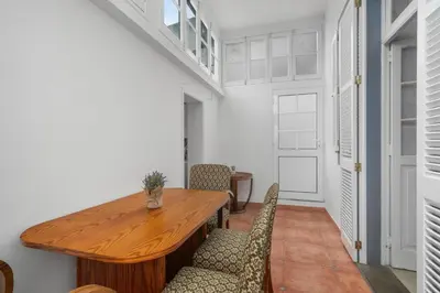 a dining room with a wooden table and chairs at Akosuah's Villa in Funchal