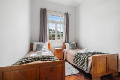 two beds in a room with a window at Akosuah's Villa in Funchal