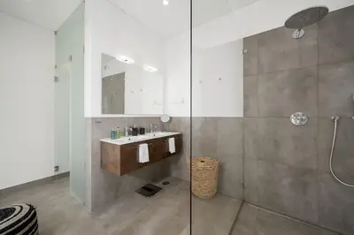a bathroom with a sink and a glass shower at Villa Vanguard by Destination Algarve in Montinhos da Luz