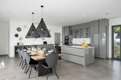 a kitchen and dining room with a table and chairs at Villa Vanguard by Destination Algarve in Montinhos da Luz