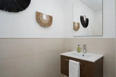 a white bathroom with a sink and a mirror at Villa Vanguard by Destination Algarve in Montinhos da Luz