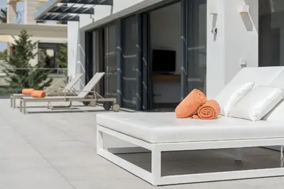 a white couch with orange towels on a patio at Villa Vanguard by Destination Algarve in Montinhos da Luz