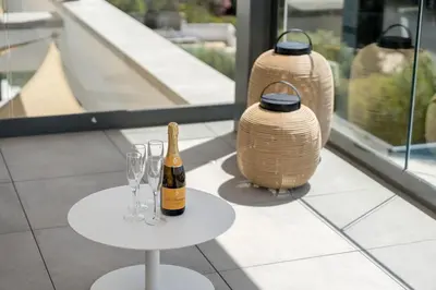 a bottle of champagne on a table with wine glasses at Villa Vanguard by Destination Algarve in Montinhos da Luz