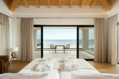 a bedroom with two beds and a view of the ocean at Villa Meridian by Destination Algarve in Mato Porcas