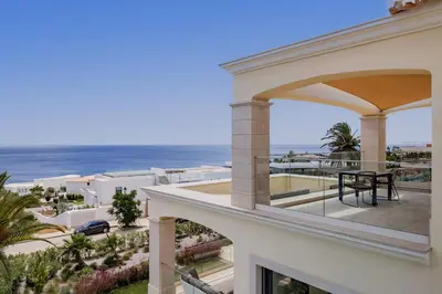 a balcony with a view of the ocean at Villa Meridian by Destination Algarve in Mato Porcas