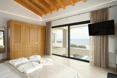 a bedroom with a bed and a large window at Villa Meridian by Destination Algarve in Mato Porcas