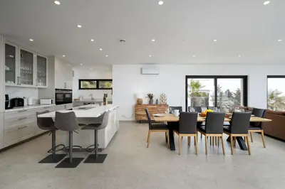 a kitchen and dining room with a table and chairs at Villa Meridian by Destination Algarve in Mato Porcas