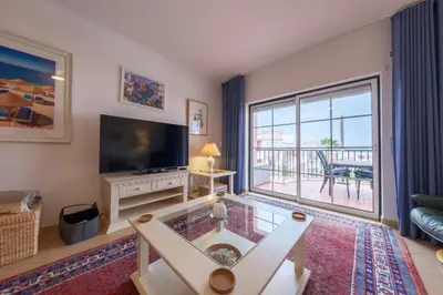 a living room with a glass table and a large window at St James 30 by Destination Algarve in Luz