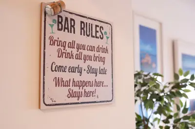 a sign for a bar rules hanging on a wall at St James 30 by Destination Algarve in Luz