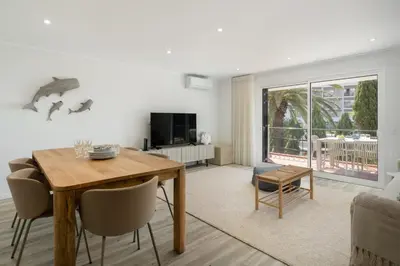 a living room with a wooden table and chairs at Promenade II by An Island Apart in Funchal