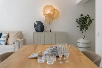 a dining room table with wine glasses on it at Promenade II by An Island Apart in Funchal