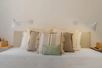 a white bed with a bunch of pillows on it at Promenade II by An Island Apart in Funchal