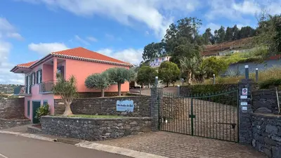 a pink house with a gate in front of it at Vila Rocha Do Sol 59B - Ensuite Room With Balcony View in Canhas
