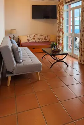 a living room with a couch and a table at Vila Rocha Do Sol 59B - Ensuite Room With Balcony View in Canhas