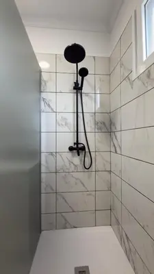 a bathroom with a shower with a black stool at Vila Rocha Do Sol 59B - Ensuite Room With Balcony View in Canhas