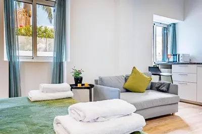 a living room with a couch and a chair at Casa Ribeiro in Funchal