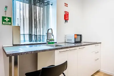 a kitchen with a sink and a window at Casa Ribeiro in Funchal