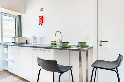 a kitchen with two chairs and a counter at Casa Ribeiro in Funchal