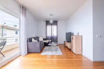 a living room with a couch and a tv at Atlantic View I By GALMI in Santa Cruz