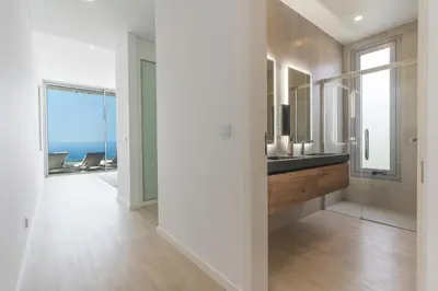 a bathroom with a sink and a view of the ocean at Villa Alegria by Atlantic Holiday in Calheta
