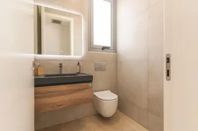 a bathroom with a sink and a toilet and a mirror at Villa Alegria by Atlantic Holiday in Calheta