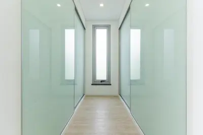 an empty corridor with glass doors and a wooden floor at Villa Alegria by Atlantic Holiday in Calheta