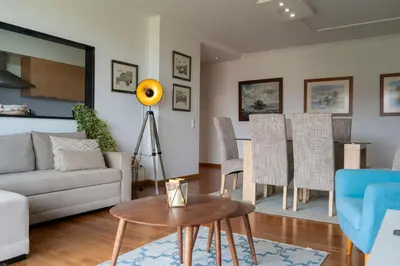 a living room with a couch and a table at Casa da Baía Overlooking Funchal Bay in Funchal