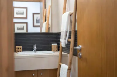 a bathroom with a sink and a mirror at Casa da Baía Overlooking Funchal Bay in Funchal