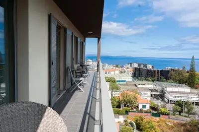 a balcony with a view of the ocean at Casa da Baía Overlooking Funchal Bay in Funchal