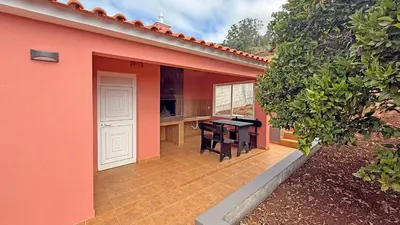a pink house with a patio with a desk at Vila Rocha Do Sol 59A - Ensuite Room With Balcony View in Canhas