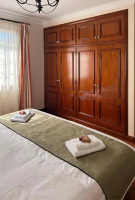 a bedroom with a large bed with wooden cabinets at Vila Rocha Do Sol 59A - Ensuite Room With Balcony View in Canhas