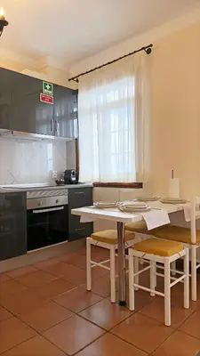 a kitchen with a table and chairs in a kitchen at Vila Rocha Do Sol 59A - Ensuite Room With Balcony View in Canhas