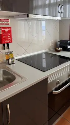 a kitchen with a sink and a counter top at Vila Rocha Do Sol 59A - Ensuite Room With Balcony View in Canhas