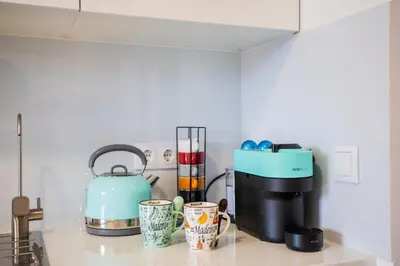 a kitchen counter with a coffee maker and cups on it at Madeira Melody in Funchal