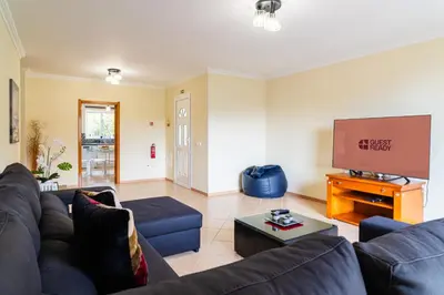 a living room with a couch and a flat screen tv at GuestReady – Charming Getaway by Madeira's Nature in Santana