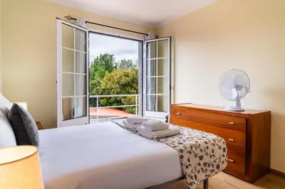 a bedroom with a bed and a large window at GuestReady – Charming Getaway by Madeira's Nature in Santana
